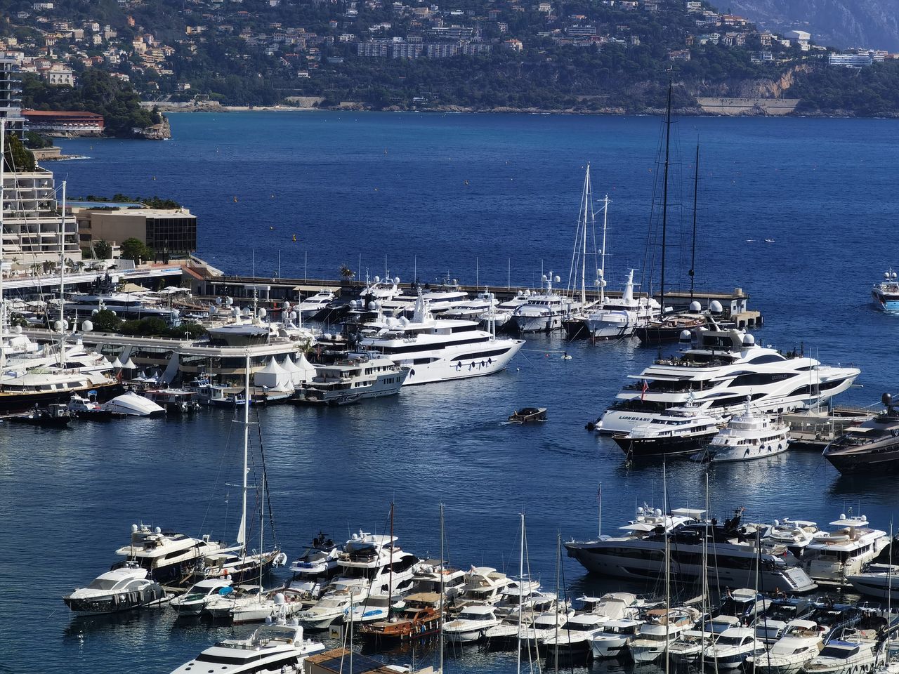 journey Discover the opulence of Monaco's marina, showcasing luxury yachts against a stunning Mediterranean backdrop.