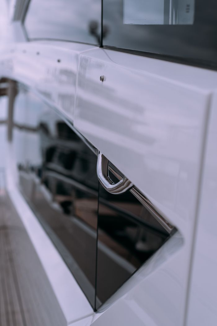 Elegant close-up view of a yacht's exterior handle with sleek design details.